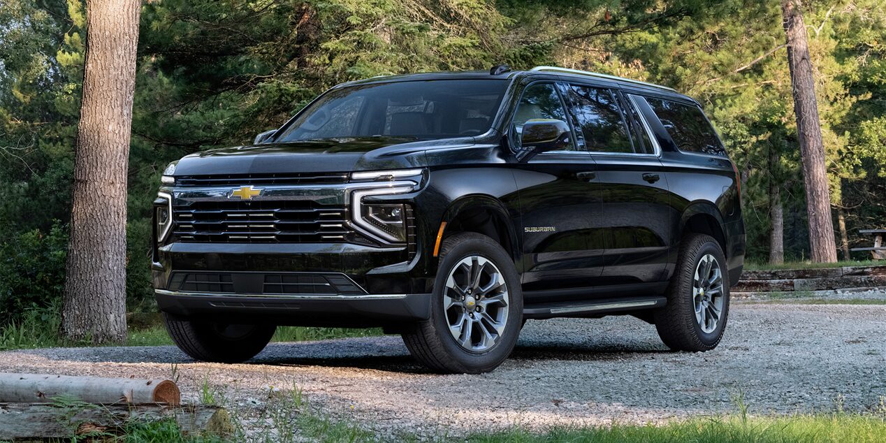 Front Three-quarters View of the 2025 Chevrolet Suburban SUV Parked on gravel