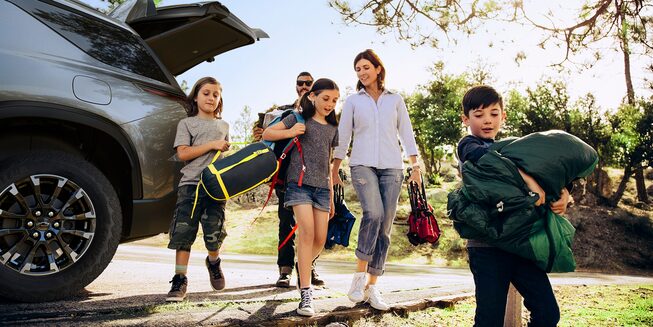 A Family Unloading Camping Gear from the Trunk of their 2024 Chevy Traverse
