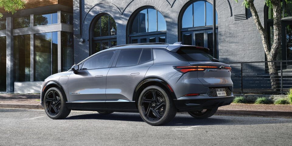 Side View of a Grey 2025 Equinox EV Next to a Building