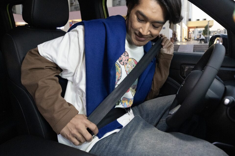 Driver securing seatbelt inside the Chevrolet Spark EUV, emphasizing safety and the 'Buckle to Drive' feature.