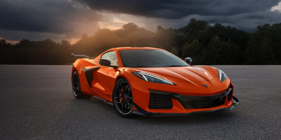 Front Three Quarters of Orange 2025 Corvette Z06 in empty road 