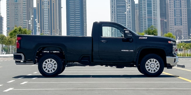 Black Chevy Silverado HD Parked in A Beautiful Open Field