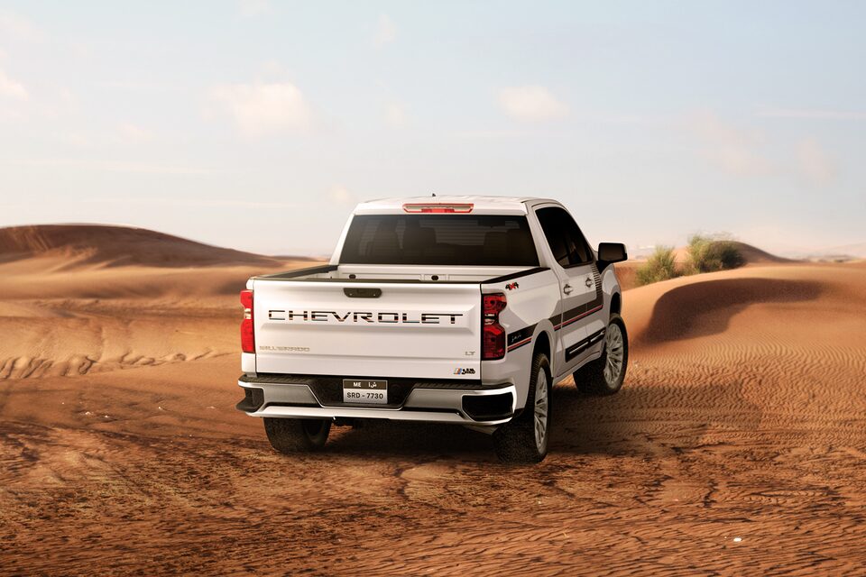 Rear view of the 2025 Chevrolet Silverado Chafar truck on sand in a desert environment.