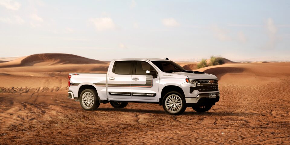 Front side view of the 2025 Chevrolet Silverado Chafar truck on sand in a desert environment.