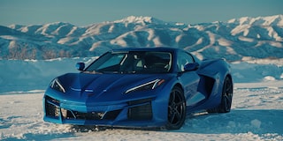 Three Quarters View of a 2025 Blue Chevy Corvette E-Ray in an Icy Plain Surrounded by Icy Mountains