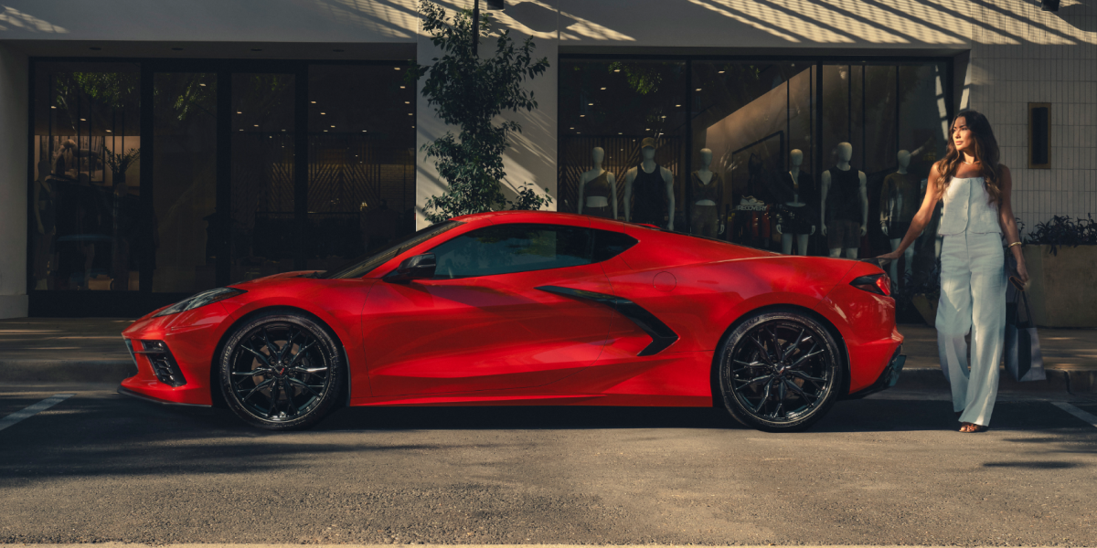 A Woman Walking Toward Her Parked 2026 Chevy Corvette Stingray