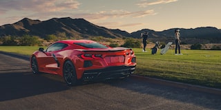 A Couple in Tennis Clothes Walking Toward Their 2026 Chevy Corvette Stingray