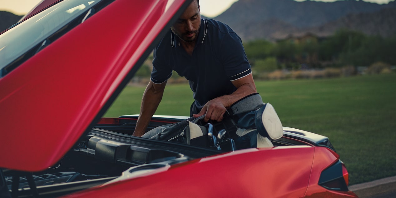 Man Loading Golf Equipment into the Trunk of the 2026 Chevy Corvette Stingray