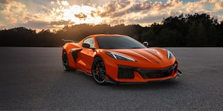 Three Quarters View of an Orange 2026 Chevy Corvette Z06 with a Setting Sun Behind It