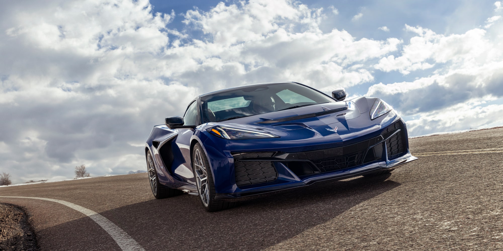 Low Angle Three Quarter View of a Purple 2026 Chevy Corvette ZR1 Going down the Road on a Sunny Day