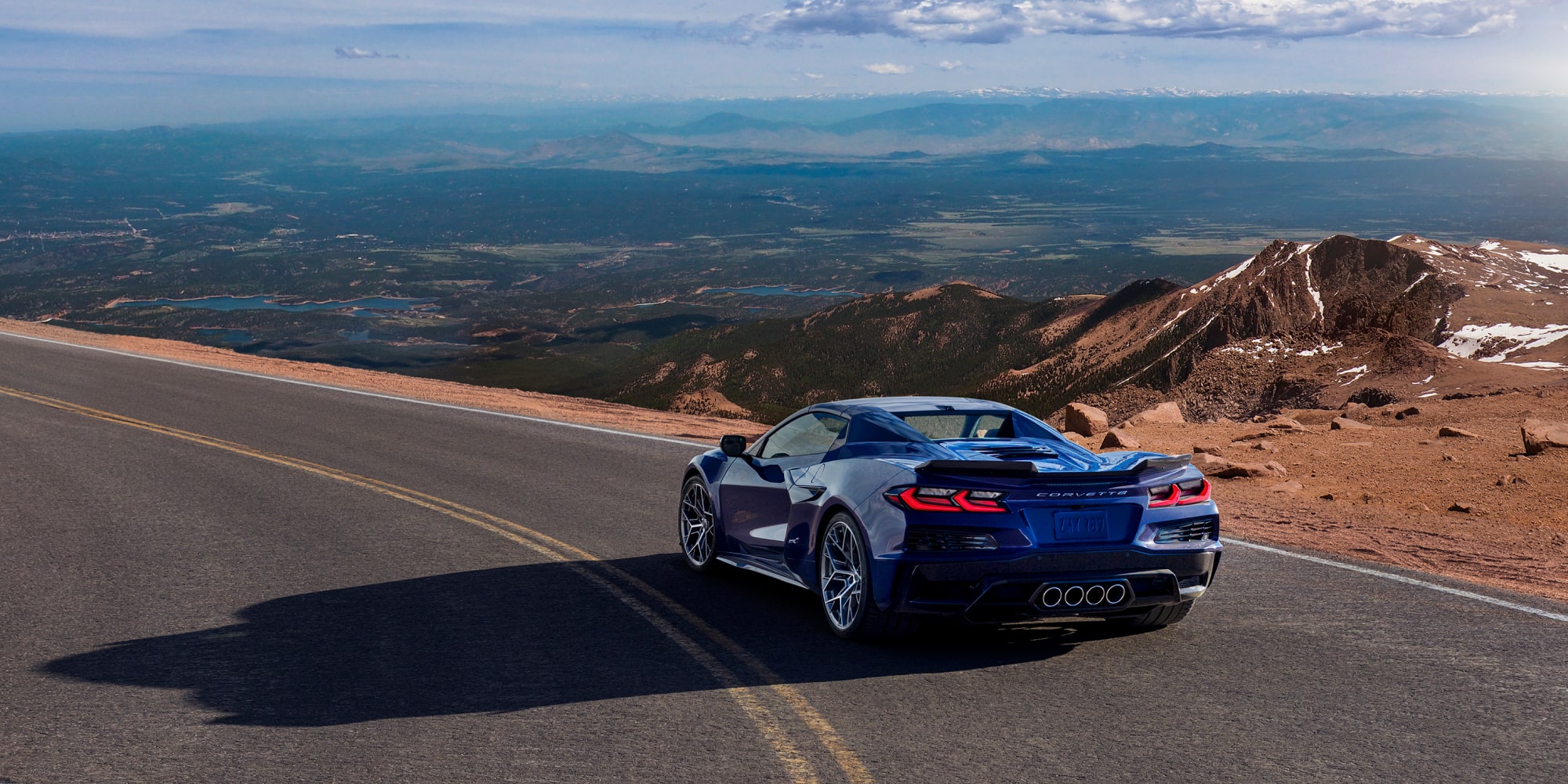 Three Quarters Rear View of a Pruple 2026 Chevy Corvette ZR1 Surrounded by Mountains