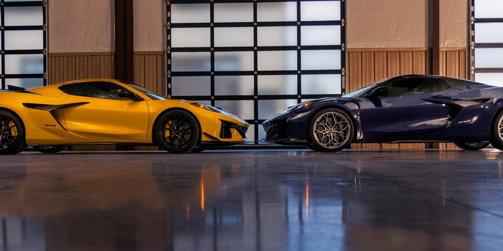 Side View of Two Pruple and Yellow 2026 Chevy Corvette ZR1 Facing Each Other in a Showroom