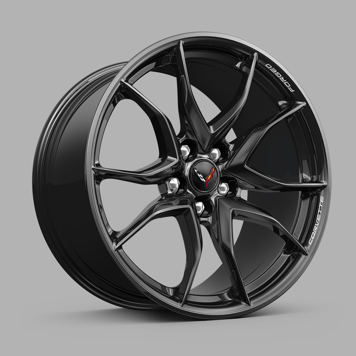 A Black Chevrolet Corvette Grand Sport Alloy Wheel With a Split‑Five‑Spoke Design Displayed Against a Gray Background.