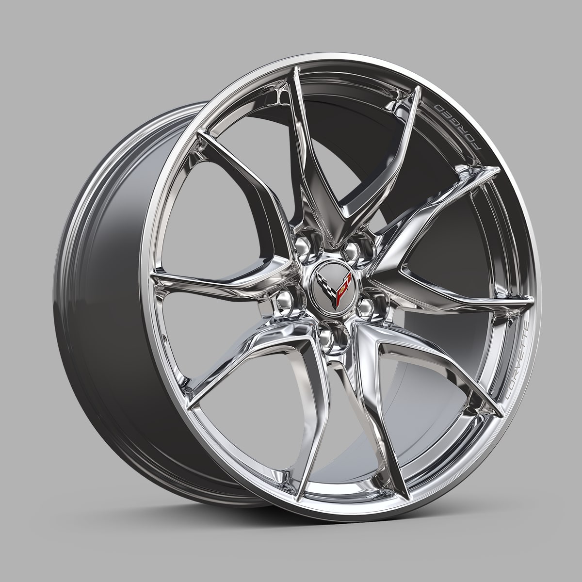 A Chrome Chevrolet Corvette Grand Sport Alloy Wheel With a Split‑Five‑Spoke Design Displayed Against a Gray Background.