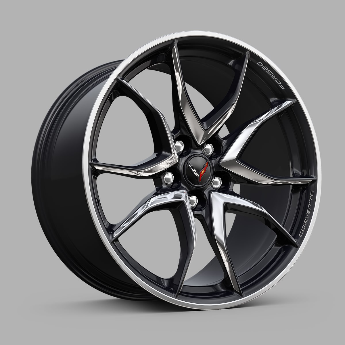 A Black Chevrolet Corvette Grand Sport Alloy Wheel With a Split‑Five‑Spoke Design Displayed Against a Gray Background.