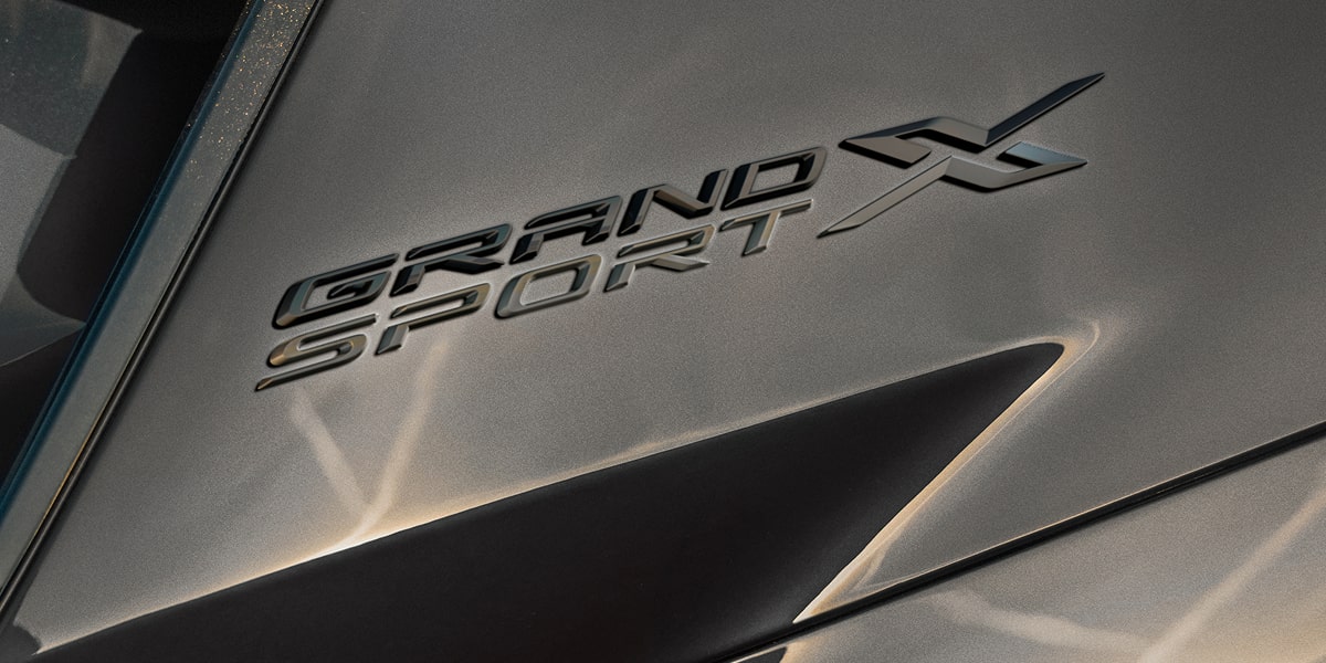 Bird's Eye View of a White Chevrolet Corvette Grand Sport Parked on Asphalt Covered in Burn Out Marks