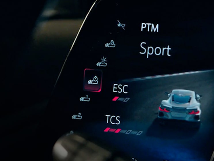 A Close‑Up View of the Digital Display Inside a Chevrolet Corvette Grand Sport Shows Performance Traction Management Settings With Sport Mode Highlighted and Icons for ESC and TCS.