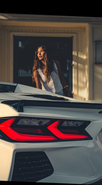 Close-Up of Rear Tail Light on the 2026 Chevy Corvette Stingray with a Woman in the Background
