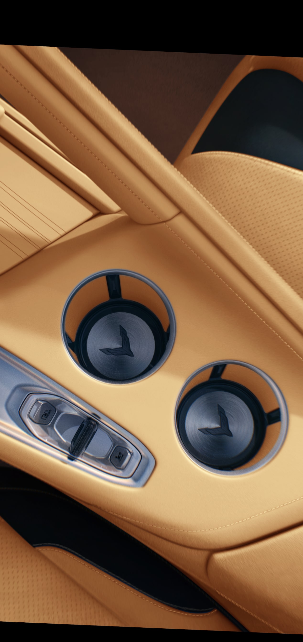 Primer plano del interior de un Chevrolet Corvette Z06 2027 con una consola central de piel en Tostado y portavasos dobles