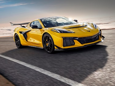 A Front Three-Quarter View of a Yellow Chevy Corvette ZR1 Parked on a Road Featuring Black Wheels, Sharp Body Lines, and the Text “Enhanced Performance Data Recorder” Displayed in the Corner.