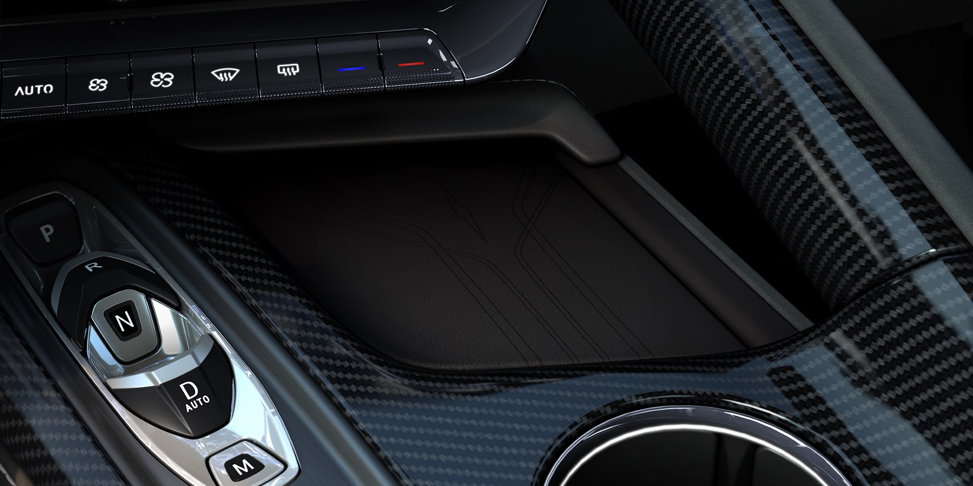 Un primer plano de la consola central de un Chevrolet Corvette Grand Sport donde se observan los controles de interruptores metálicos junto al juego de dos portavasos circulares en un modelo con el interior rojo.