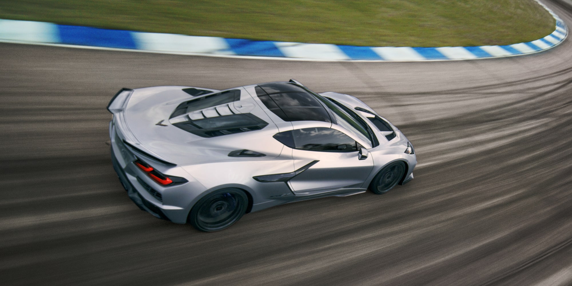 2027 Chevy Corvette ZR1X Racing Around a Bend on a Racetrack
