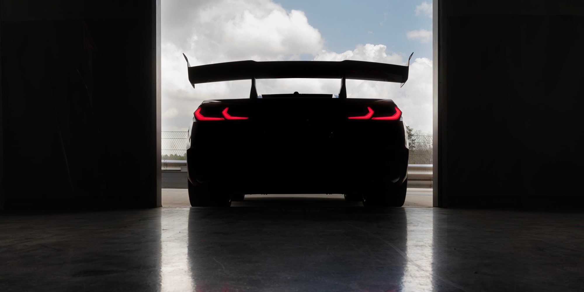 2027 Chevy Corvette ZR1X Racing Around a Bend on a Racetrack