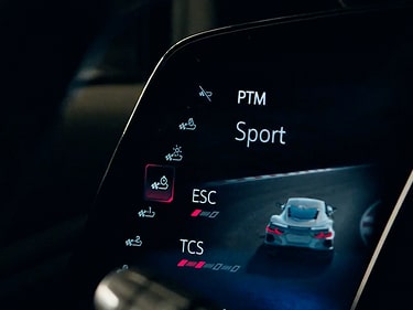 A Close-Up of the Performance Traction Management Interface on the Chevy Corvette ZR1X Displaying “Sport” Mode on a Digital Screen with the Text “Performance Traction Management” Visible Along the Side.