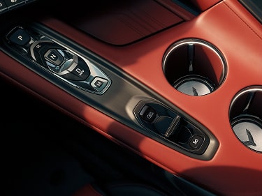 A Close-Up of the Center Console Inside the Chevy Corvette ZR1X Featuring Drive Mode Buttons, Dual Cup Holders, and Red Interior Trim with the Text “Drive Modes” Visible in the Lower Corner.