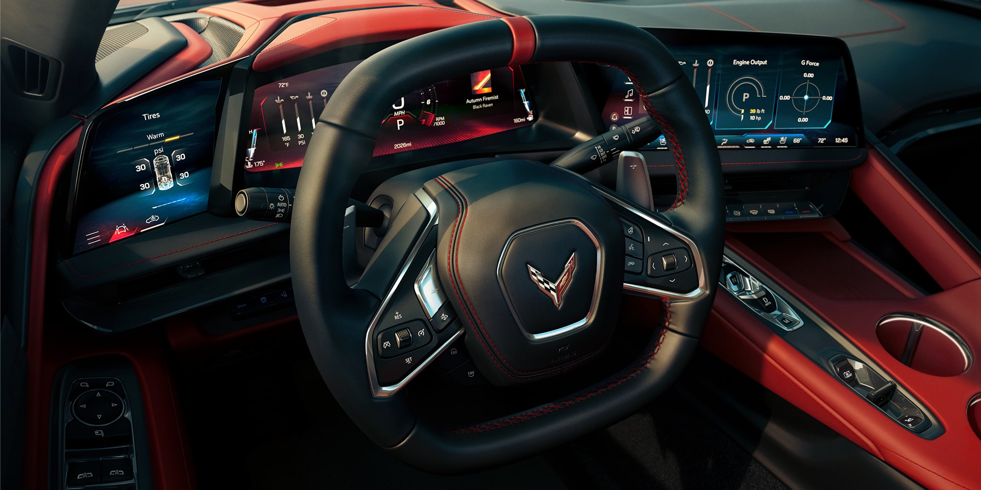 Interior View of a Red and Black Chevy Corvette Stingray Steering Wheel and the Vehicle's Driver Display Info Screens