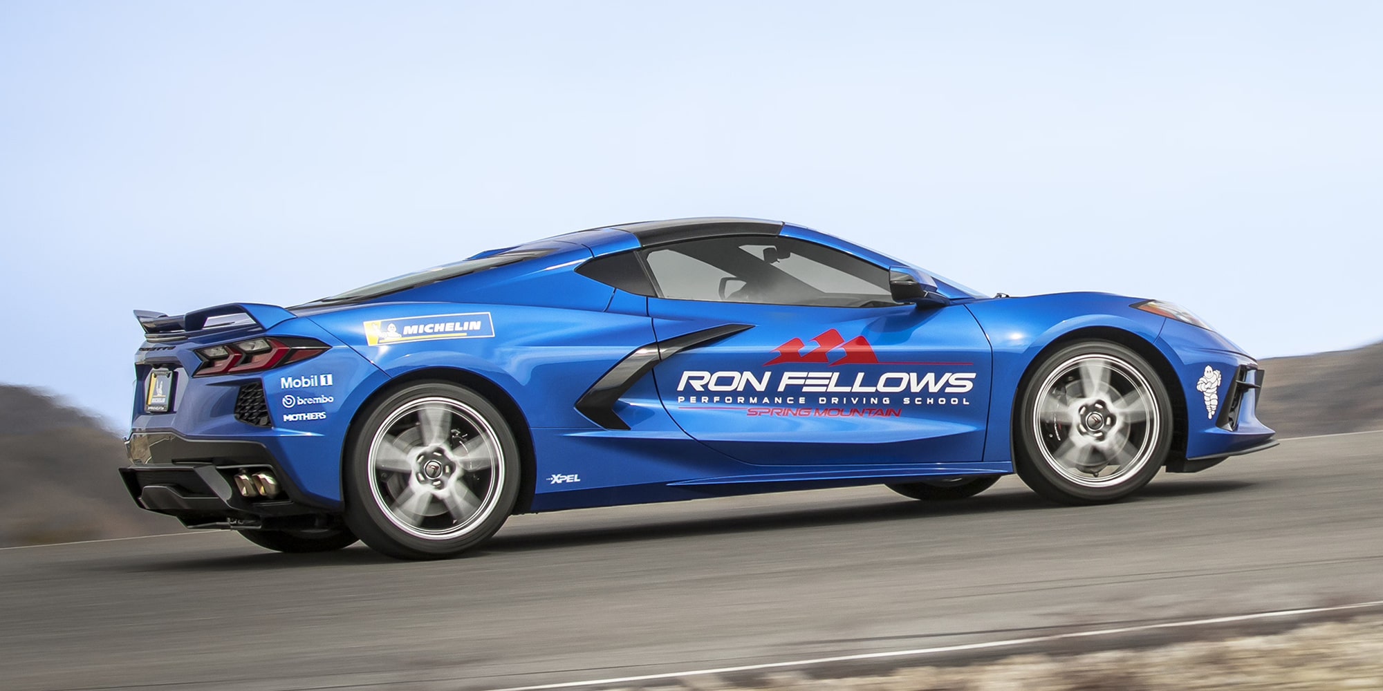  A Blue Chevy Corvette Sports Car Driving on a Highway