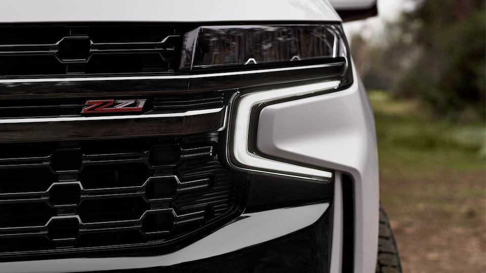 A closeup of the Z71 badge on the grille of a 2021 Chevy Tahoe.