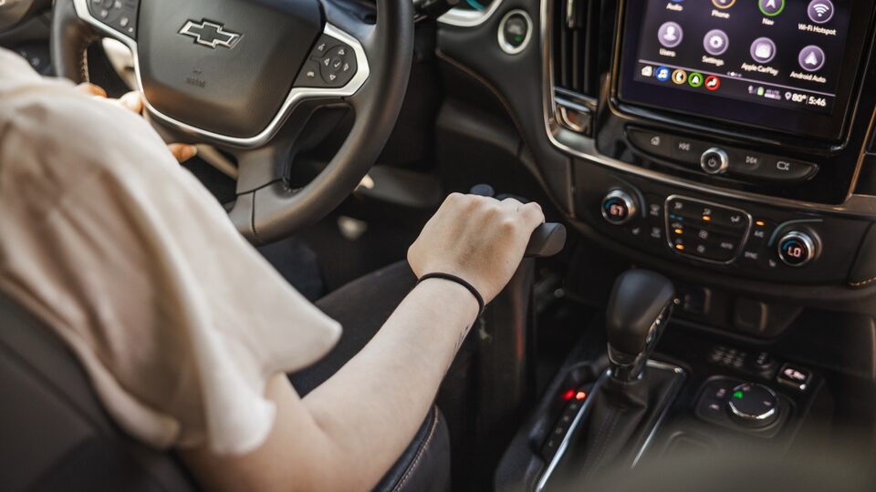 Viewed from behind, Joanna Bonilla uses the hand controls in her Traverse.