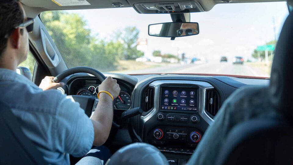 Interior shot of Jon Hagar in the driver’s seat of the Chevrolet Silverado.