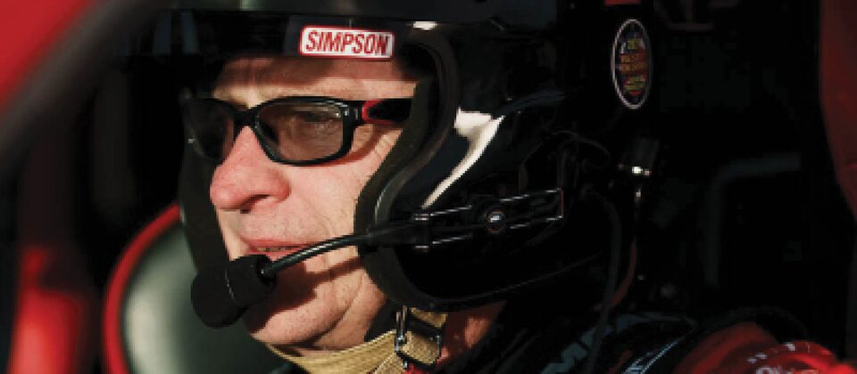 A closeup of Chad Hall, dressed in safety gear, in the driver's seat of his Colorado ZR2.