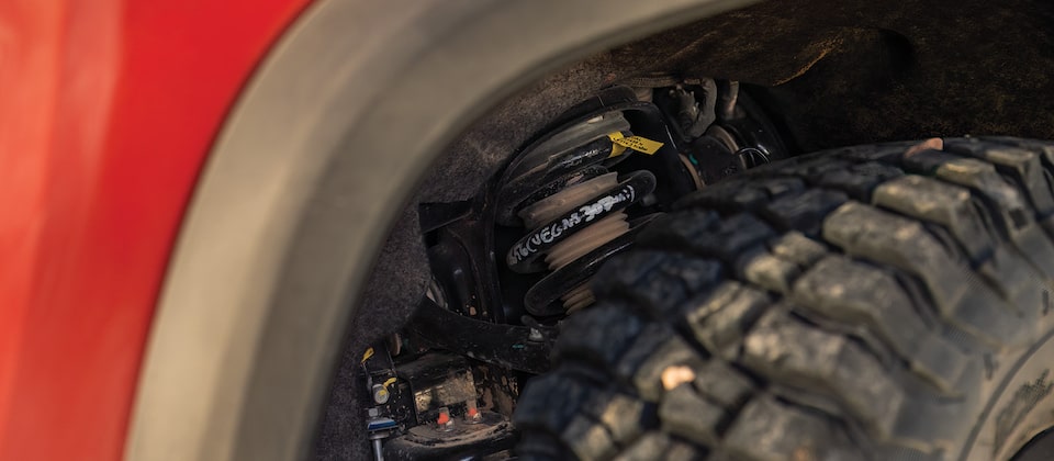 Zoomed in on the top of one wheel and the wheel well of Chad Hall's Colorado ZR2, showing the DSSV shock absorbers.