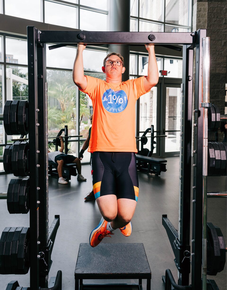 Chris Nikic entrena en la barra de tracción de un gimnasio.