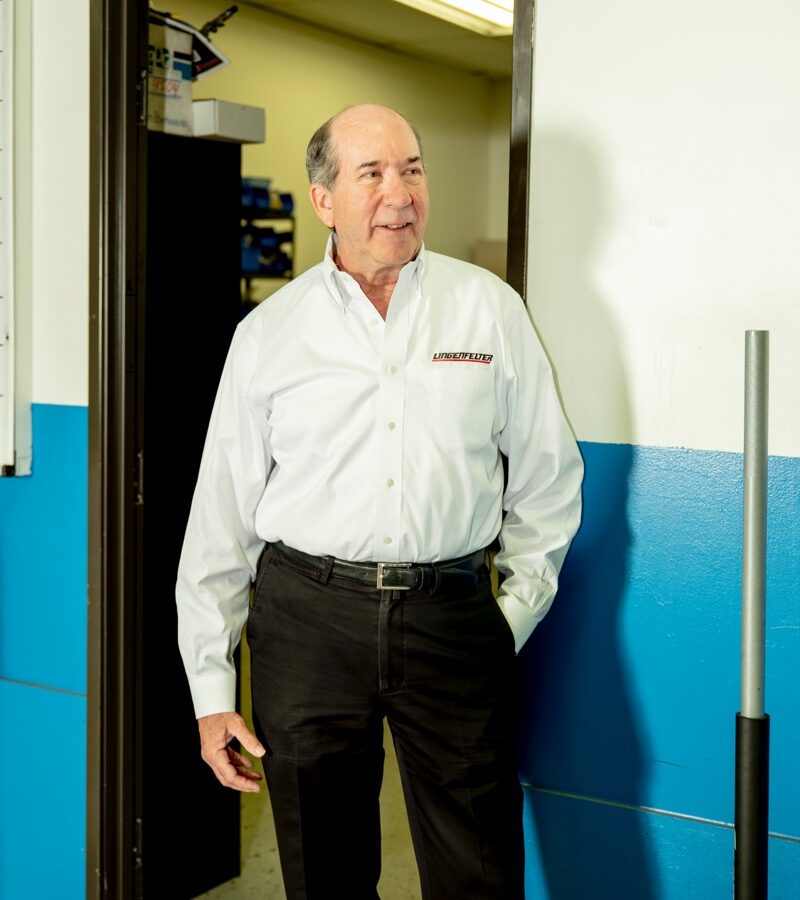 Ken Lingenfelter, owner and CEO of Lingenfelter Performance Engineering, stands in a doorway in the shop.