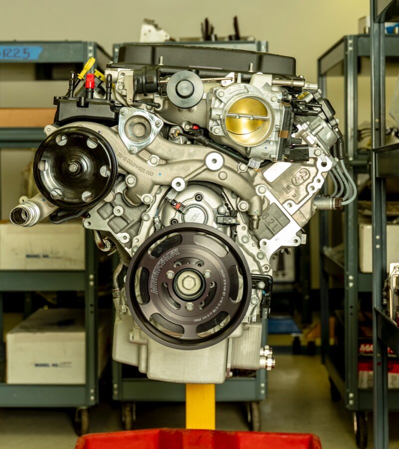 A traditional combustion engine sits on a stand in the Lingenfelter shop.