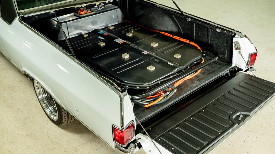 Batteries and wiring inside the open bed of a 1972 El Camino that has been converted to electric.