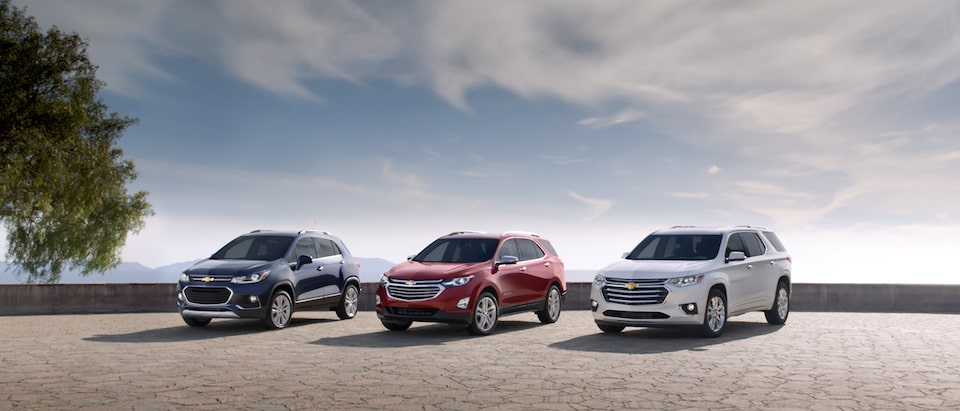 Chevrolet Trax, Equinox and Traverse crossovers parked next to each other.