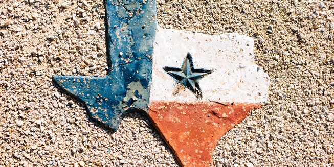 A red, white and blue sculpture in the shape of Texas.