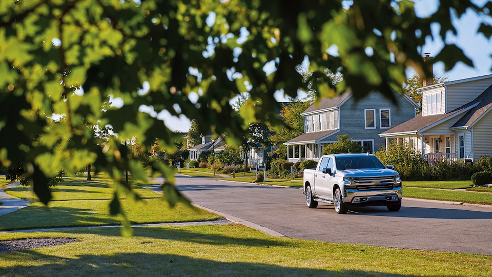 A 2019 Chevy Silverado Crew Cab drives past houses in an agrihood neighborhood.