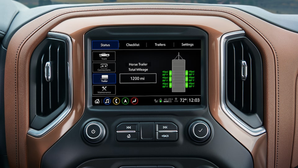 The infotainment screen displays trailer stats as part of the in-vehicle trailering system.