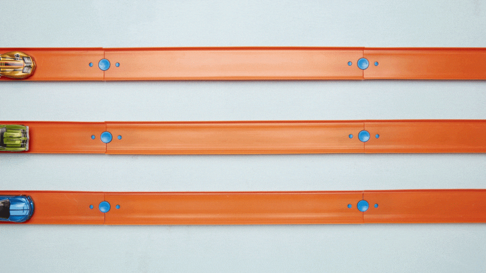A gif animation of three Hot Wheels cars moving from left to right across three separate orange Hot Wheels tracks.