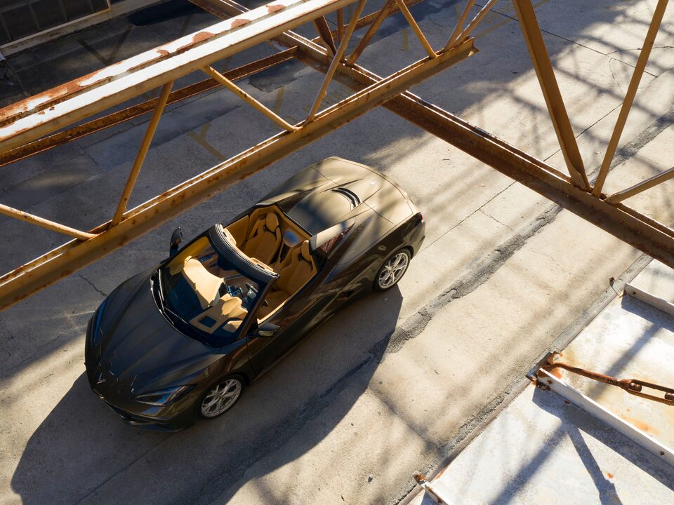 A 2020 Corvette Convertible in Zeus Bronze Metallic seen from above as it drives on a road in the Charleston Navy Yard in South Carolina.