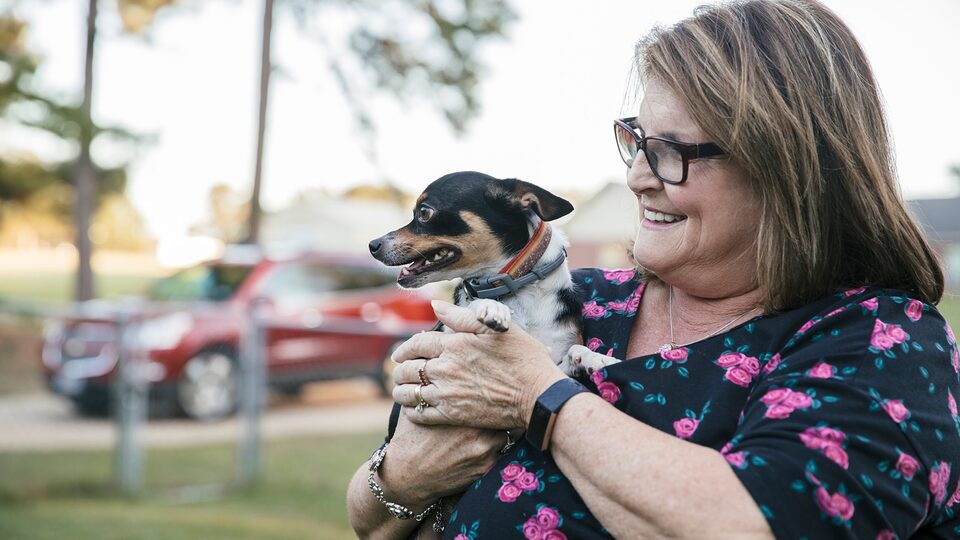 OnStar Member Teresa Moore holds her small dog.