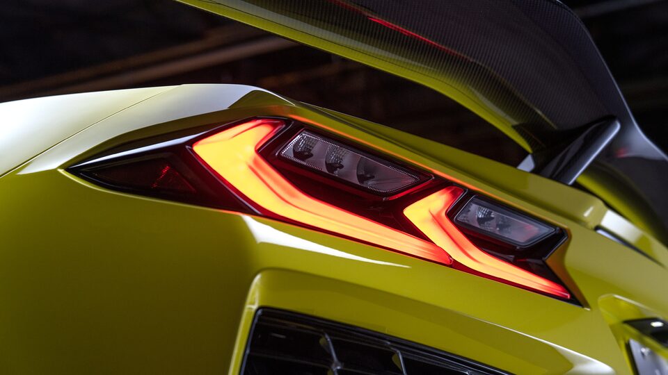 A closeup of a tail light on a yellow Corvette Z06.