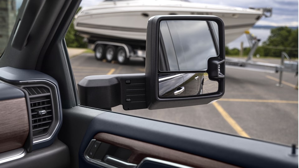 A closeup of the right-hand side-view mirror on a Silverado HD, showing how you can simultaneously get two different views toward the back of the truck from the same mirror.
