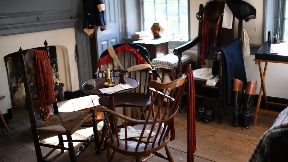 Historic chairs and garments in a living area in Washington’s headquarters at Valley Forge.